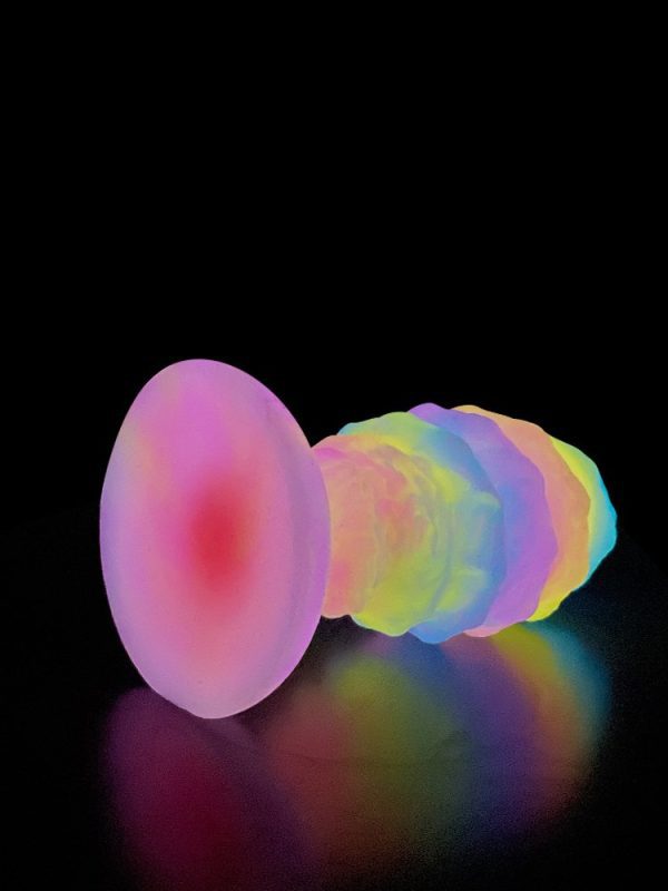 A glow-in-the-dark silicone anal plug, designed for safe and pleasurable use, with a smooth finish and a subtle light emitting feature