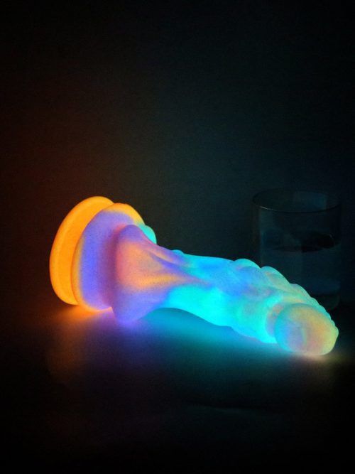 A glowing, uniquely shaped monster dildo designed for adventurous pleasure.