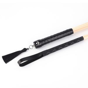 A bamboo whip with a black handle, showcasing its sleek design and craftsmanship