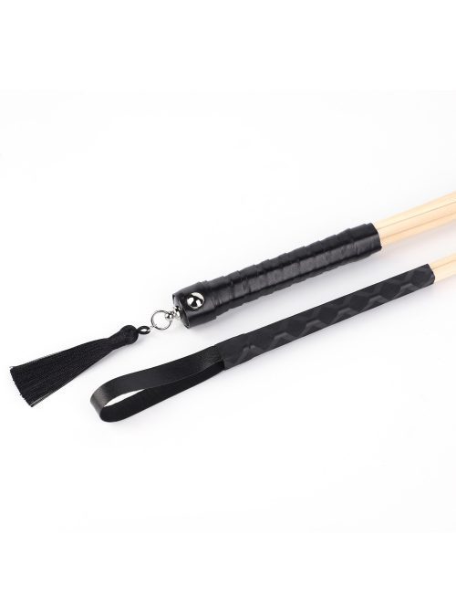 A bamboo whip with a black handle, showcasing its sleek design and craftsmanship