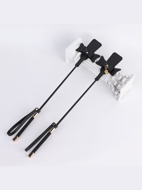 A stylish leather whip adorned with a charming bow tie, perfect for adding flair to your intimate play