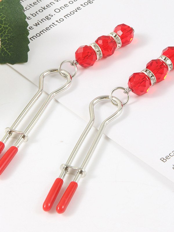 Elegant nipple clip adorned with a sparkling pendant, showcasing a blend of luxury and sensuality
